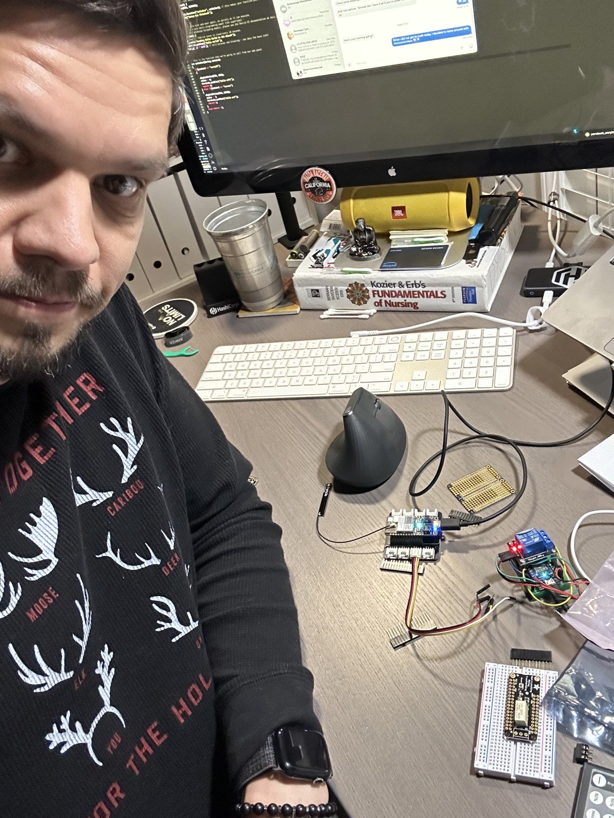 Desk covered in dev boards and relays